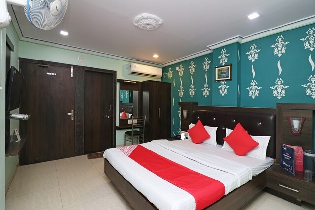 Deluxe Room at Hotel Madani - Contemporary room with AC, TV, and comfortable furnishings